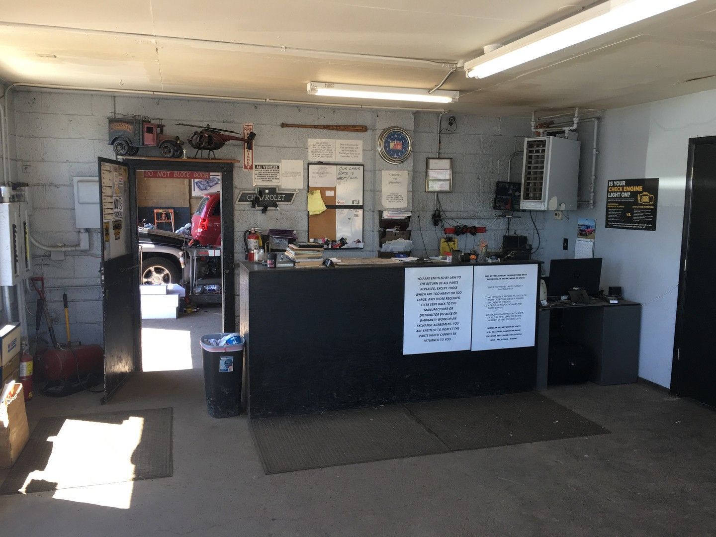 The front counter inside the shop, with a doorway into the service area